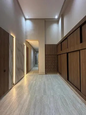 an empty room with wood panels and a hallway at Cosy Appartement de Luxe F3 Menara Garden Hivernage Marrakech avec piscine in Marrakech