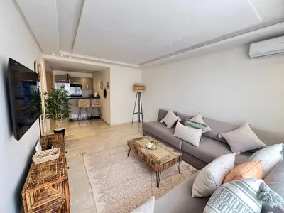 a living room with a couch and a table at Luxury studio Gueliz AC Downtown Wi-Fi in Marrakech