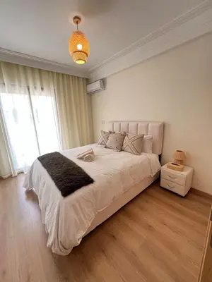 a bedroom with a large bed with a large window at Luxury studio Gueliz AC Downtown Wi-Fi in Marrakech