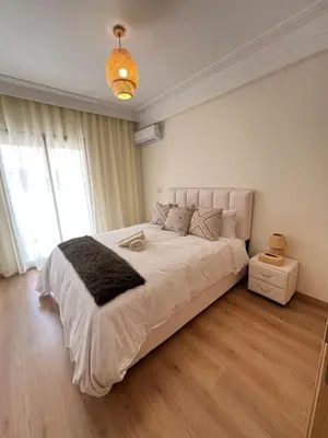a bedroom with a large bed with a large window at Luxury studio Gueliz AC Downtown Wi-Fi in Marrakech