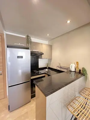 a kitchen with a stainless steel refrigerator and a counter at Luxury studio Gueliz AC Downtown Wi-Fi in Marrakech