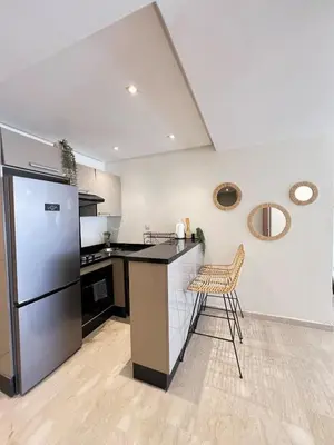 a kitchen with a counter and a refrigerator at Luxury studio Gueliz AC Downtown Wi-Fi in Marrakech