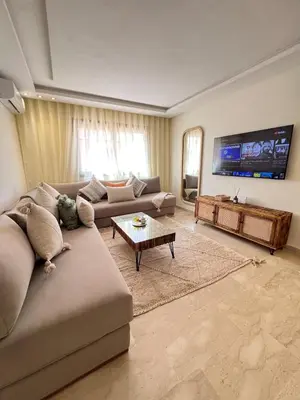 a living room with a couch and a tv at Luxury studio Gueliz AC Downtown Wi-Fi in Marrakech