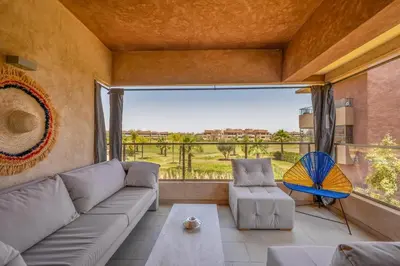a living room with a couch and a large window at Marrakech, mon amour in Marrakech