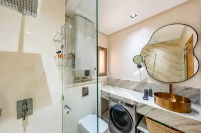 a bathroom with a shower and a sink and a mirror at Marrakech, mon amour in Marrakech