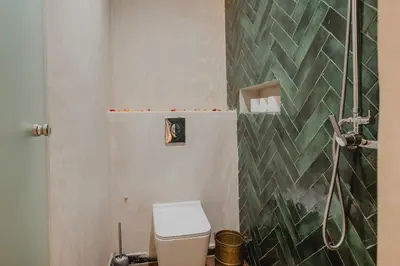 a bathroom with a toilet and a shower at Riad Al Mechouar in Marrakech