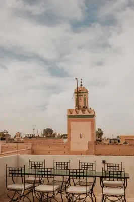 a group of chairs sitting on top of a building at Riad Al Mechouar in Marrakech