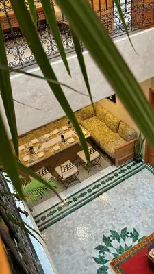 a living room with a couch and a table at Riad Al Mechouar in Marrakech