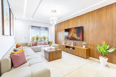 a living room with a couch and a table at Appart 3 CH Menara Garden in Marrakech