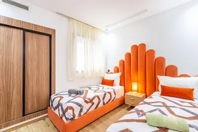 a bedroom with two beds and a large window at Appart 3 CH Menara Garden in Marrakech