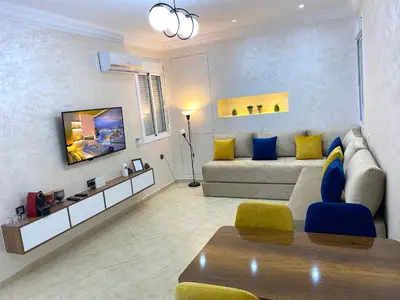a living room with a couch and a table at Appartement à Marrakech confortable et équipe in Marrakech