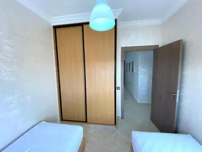 a room with a wooden closet and a door at Appartement à Marrakech confortable et équipe in Marrakech