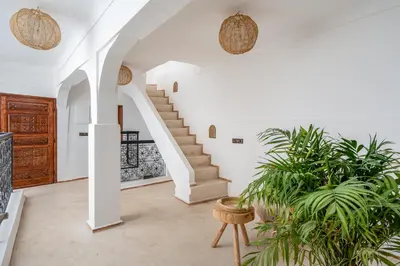 an open living room with stairs and plants at Riad Zahra Private Pool and Breakfast10min Jemaa in Marrakech