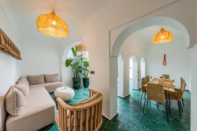 a living room with a couch and a table at Riad Zahra Private Pool and Breakfast10min Jemaa in Marrakech