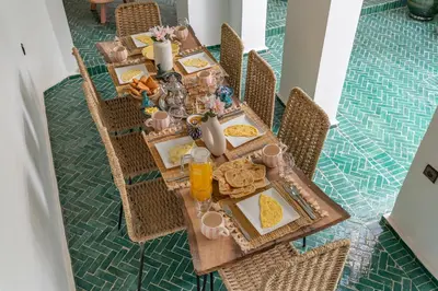 a dining table with food and drinks on it at Riad Zahra Private Pool and Breakfast10min Jemaa in Marrakech
