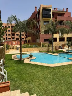 a swimming pool in front of a building at Bel Appartement 2 Chambres spacieux avec Piscine in Marrakech