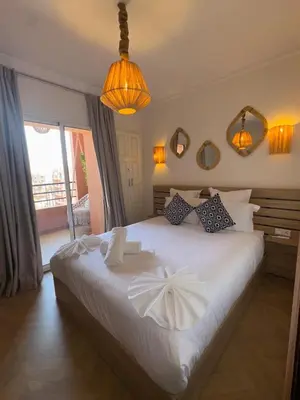 a bedroom with a large white bed with two pillows at Elegant apartment in Guéliz in Marrakech