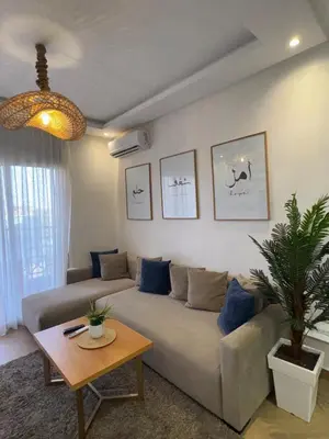 a living room with a couch and a table at Elegant apartment in Guéliz in Marrakech
