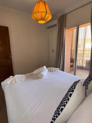 a large white bed in a bedroom with a lamp at Elegant apartment in Guéliz in Marrakech