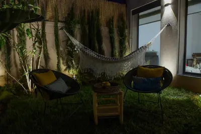 a hammock in a yard with two chairs at Luxury Villa Olivier, Stylish & Breakfast included in Marrakech