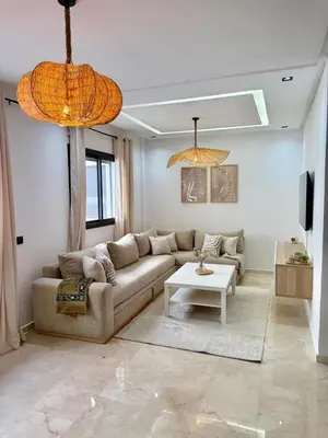 a living room with a couch and a table at Beautiful modern apartment 1 bedroom 2 people Menara Garden 2 in Marrakech