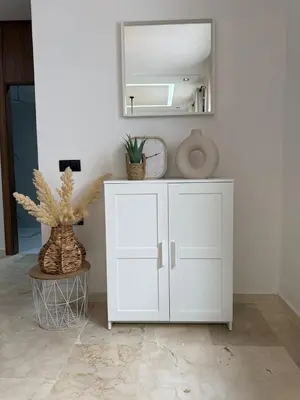 a white cabinet in a room with a mirror at Beautiful modern apartment 1 bedroom 2 people Menara Garden 2 in Marrakech