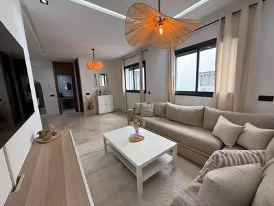 a living room with a couch and a table at Beautiful modern apartment 1 bedroom 2 people Menara Garden 2 in Marrakech