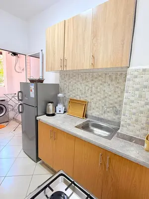a kitchen with a sink and a refrigerator at 2 Aprt Moderne Neuf Adapté Au Famille in Marrakech