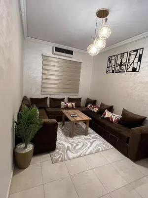 a living room with a couch and a table at aboube gulize marrakeche in Marrakech
