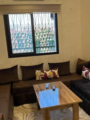 a living room with a couch and a coffee table at aboube gulize marrakeche in Marrakech