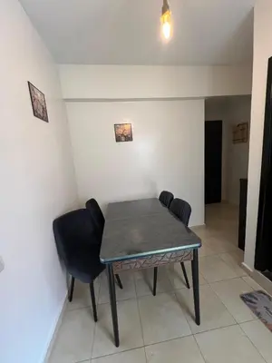 a dining room with a table and chairs at aboube gulize marrakeche in Marrakech
