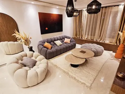 a living room with two couches and a table at Luxurious New Designer Apartment in Marrakech in Marrakech