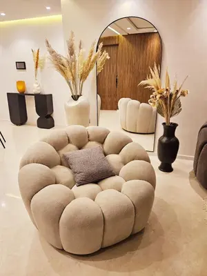 a living room with a brown tufted couch at Luxurious New Designer Apartment in Marrakech in Marrakech