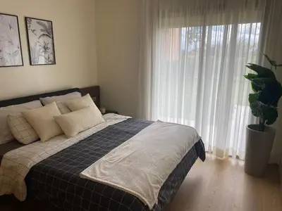 a bedroom with a bed and a large window at appartement à prestigia golf marrakech- SAPHIR in Marrakech