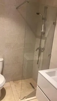 a glass shower in a bathroom with a toilet at appartement à prestigia golf marrakech- SAPHIR in Marrakech