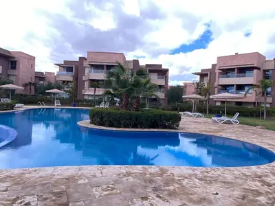 a large swimming pool in front of a building at appartement à prestigia golf marrakech- SAPHIR in Marrakech