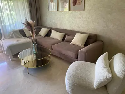 a living room with a couch and a table at appartement à prestigia golf marrakech- SAPHIR in Marrakech