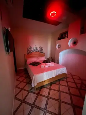 a bedroom with a bed with a red light at Riad Darkom Private in Marrakech