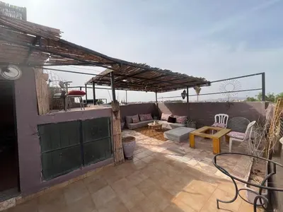 a patio with a couch and a table at Riad Darkom Private in Marrakech