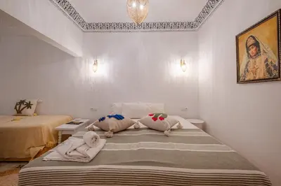 a bedroom with two beds with towels on them at Riad fabi in Marrakech