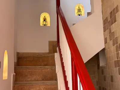 a staircase with red railings in a building at Your Soul's Retreat-Entire Riad in Marrakech