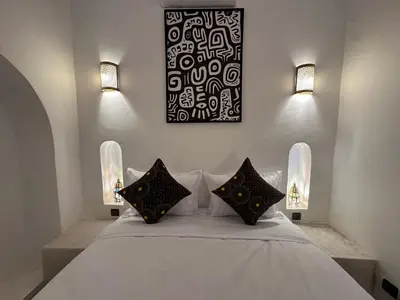 a bedroom with a white bed with two pillows at Your Soul's Retreat-Entire Riad in Marrakech