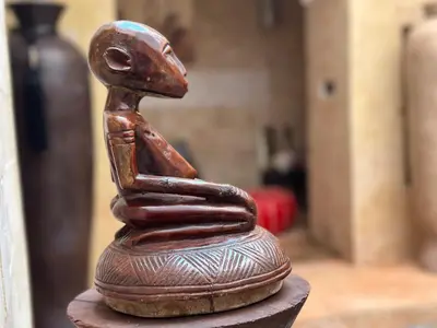 a statue of a person sitting on a vase at Your Soul's Retreat-Entire Riad in Marrakech