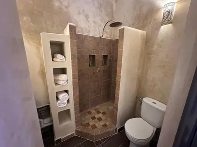 a small bathroom with a toilet and a shower at Your Soul's Retreat-Entire Riad in Marrakech