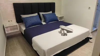 a bedroom with a large bed with blue pillows at Charming Marrakech Appartement in Marrakech