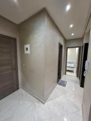 a large room with a large wall with a door at Modern Marrakech Apartment in Marrakech