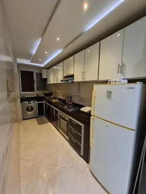 a kitchen with a white refrigerator and a stove at Modern Marrakech Apartment in Marrakech