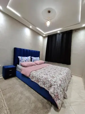 a bedroom with a blue bed and a window at Modern Marrakech Apartment in Marrakech