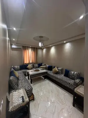 a living room with a couch and a table at Modern Marrakech Apartment in Marrakech