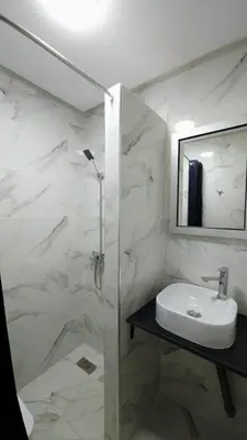a bathroom with a sink and a glass shower at Charming Marrakech Duplex in Marrakech